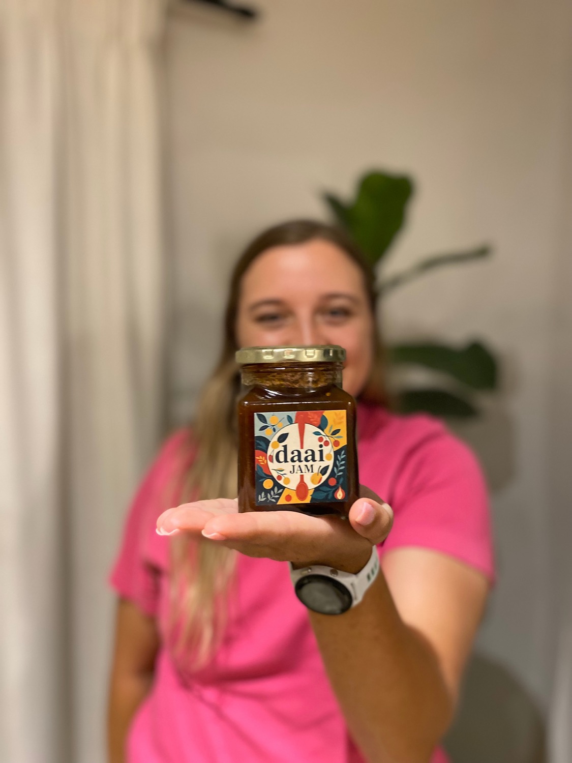 Holding a jar of Daai Jam